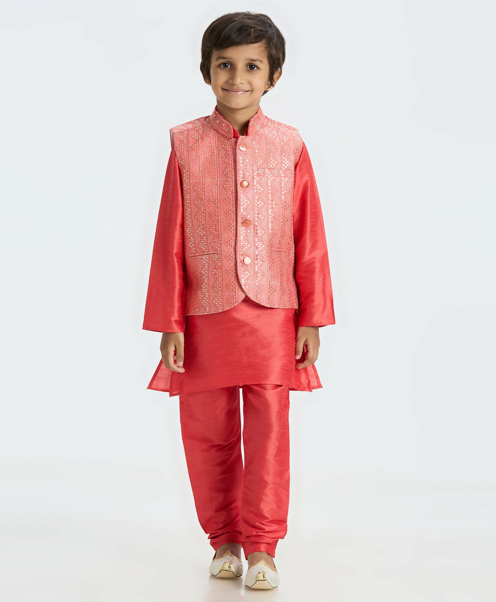 A boys' tomato red kurta pajama set featuring a matching sequin Nehru jacket, perfect for festive occasions.