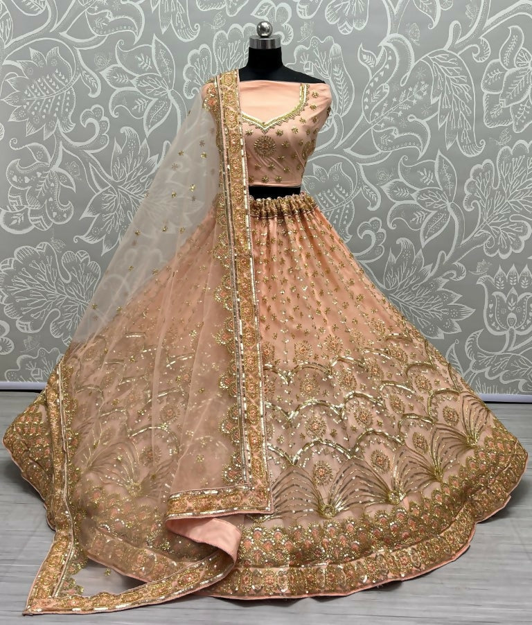 Peach bridal net lehenga with sequins, thread embroidery, and handwork