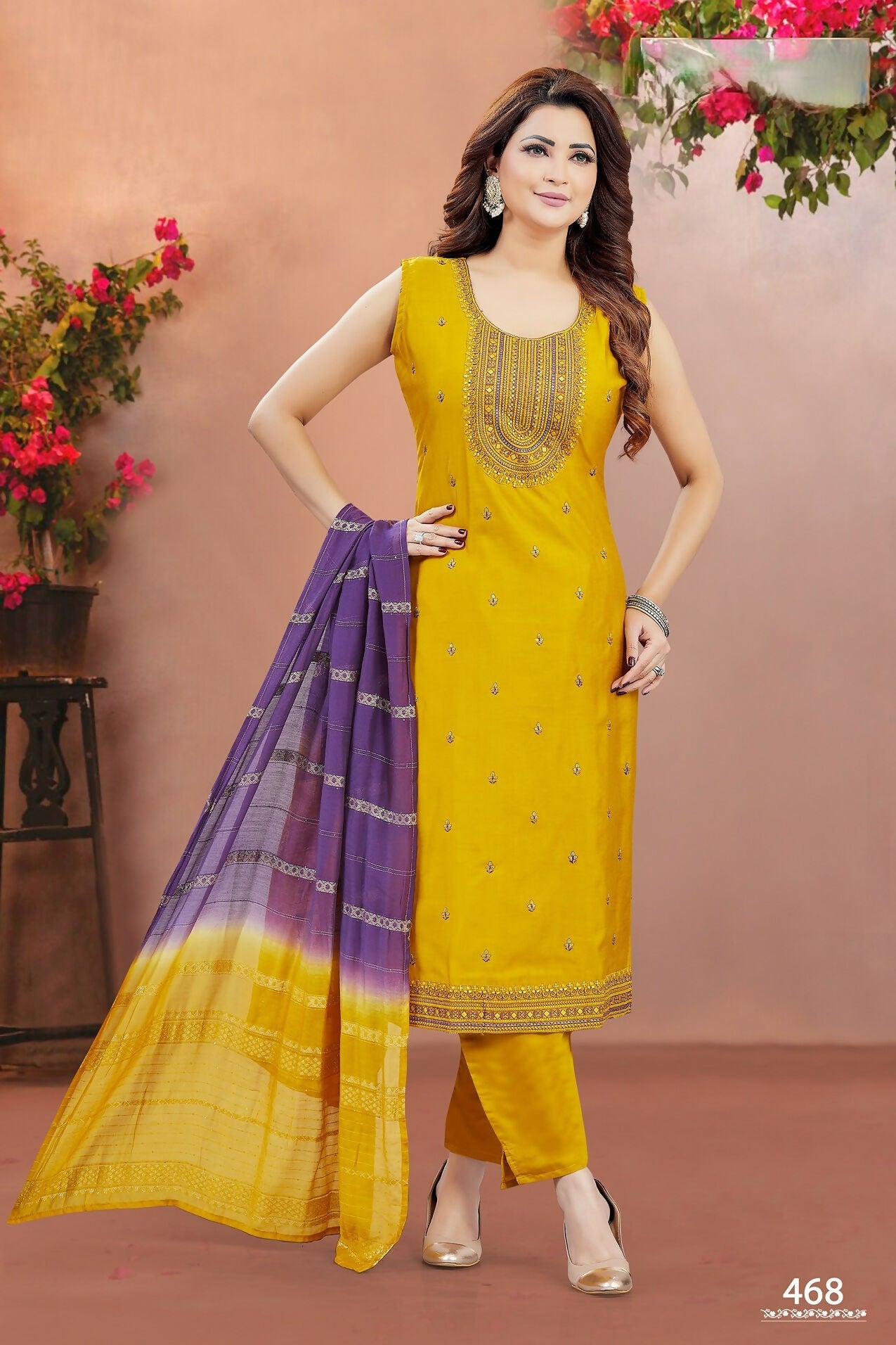 Yellow soft silk round neck kurta set with intricate embroidery and matching bottoms