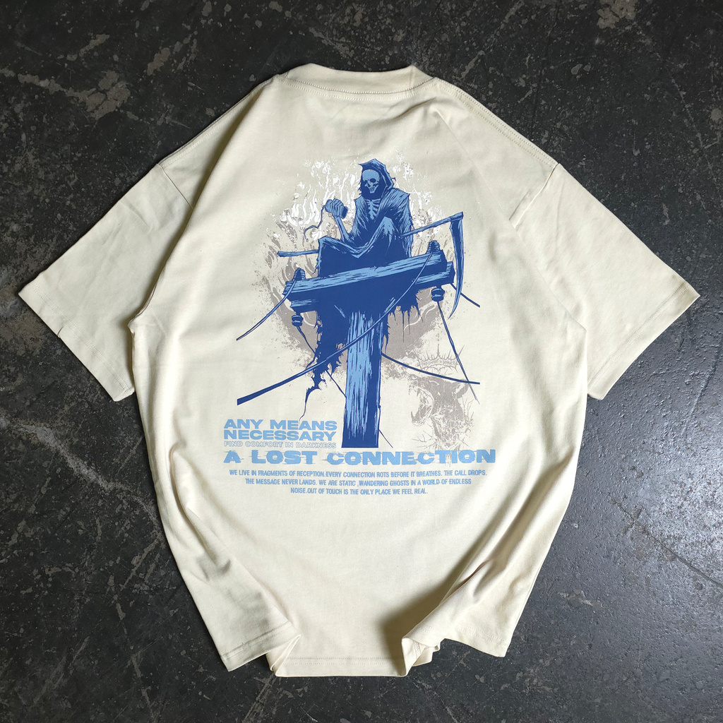 Back of an oversized bone-colored t-shirt with a grim reaper graphic sitting on a telephone pole and text about lost connections.