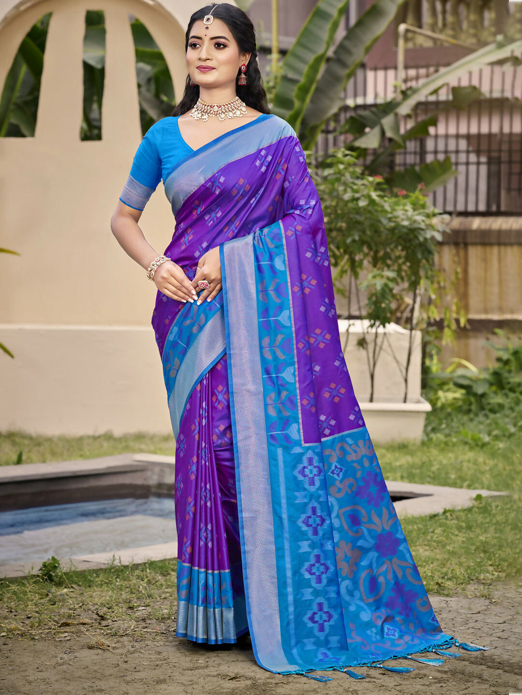 Elegant violet Pochampalli silk saree with royal blue blouse and geometric silver metallic trim detailing.