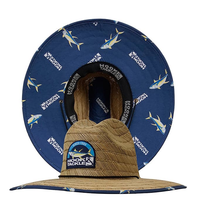 A tan straw lifeguard hat with a yellowfin tuna print under the brim and a black adjustable chin strap.