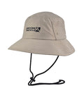 Tan fishing bucket hat with a logo, ventilation holes, and an adjustable black chin strap