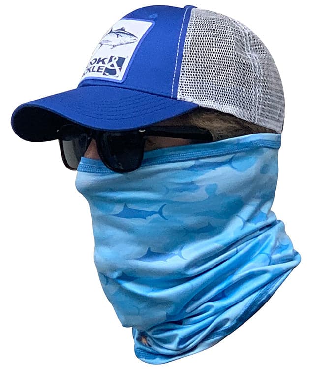 A person wearing a blue marlin camo print neck gaiter and a blue trucker hat while fishing.