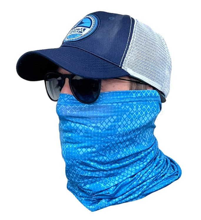 A person wearing a blue geometric pattern neck gaiter for fishing with a blue baseball cap and sunglasses.