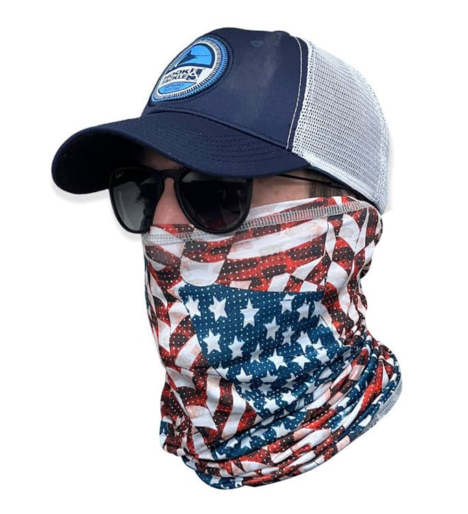 A person wearing an Americana flag print neck gaiter for fishing sun protection.