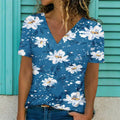A woman wearing a casual blue floral print V-neck t-shirt with short sleeves.