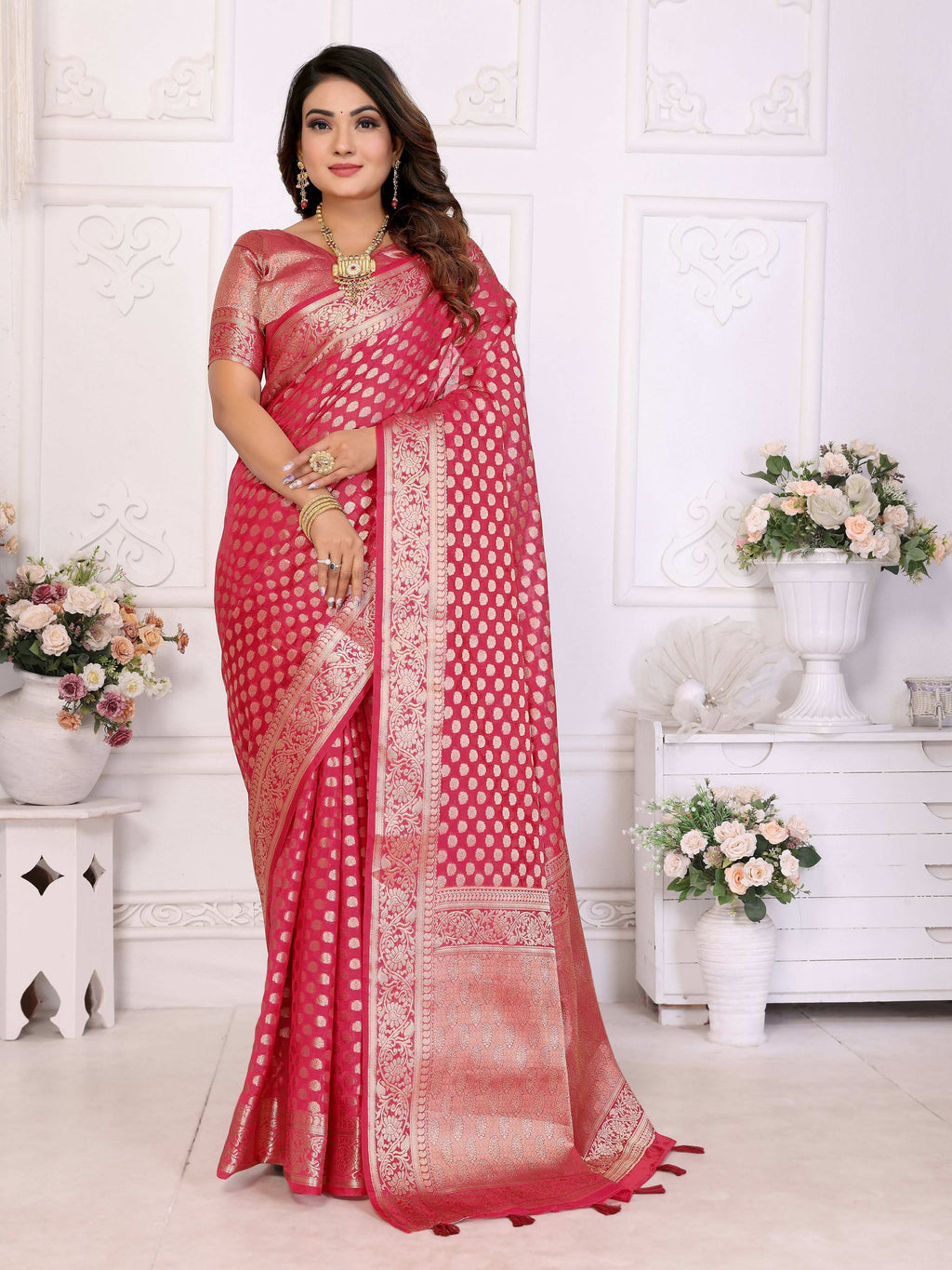 Vibrant magenta organza silk saree with detailed woven patterns