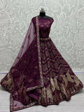 Woman wearing a purple bridal net lehenga choli with sequin and thread embroidery
