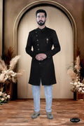 Boys wearing a stylish black satin kurta and pyjama set with self-design pattern.