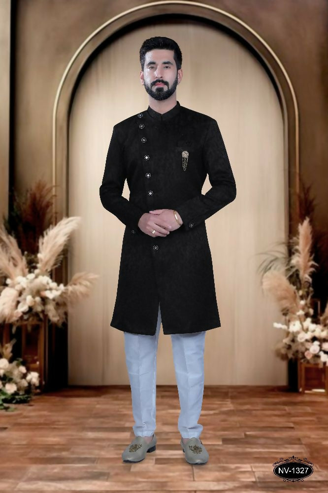 Boys wearing a stylish black satin kurta and pyjama set with self-design pattern.