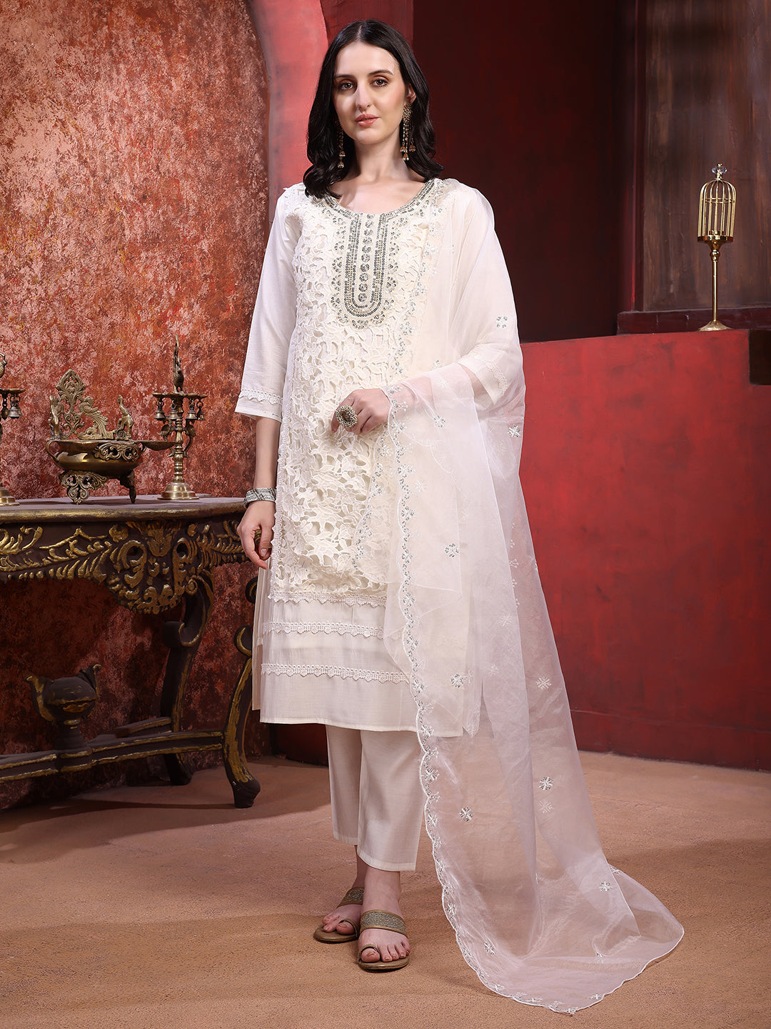 Woman wearing a cream Chanderi kurta set with applique embroidery and matching dupatta