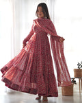 Woman wearing a maroon Kalamkari print soft georgette Anarkali dress with flare and matching dupatta