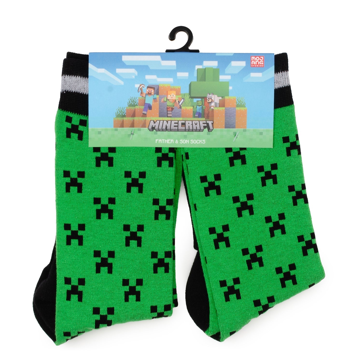 A set of green and black Minecraft Creeper patterned socks for father and son hanging on a retail display card.