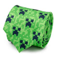 A green men's necktie featuring an all-over dark pixelated Minecraft Creeper face pattern.