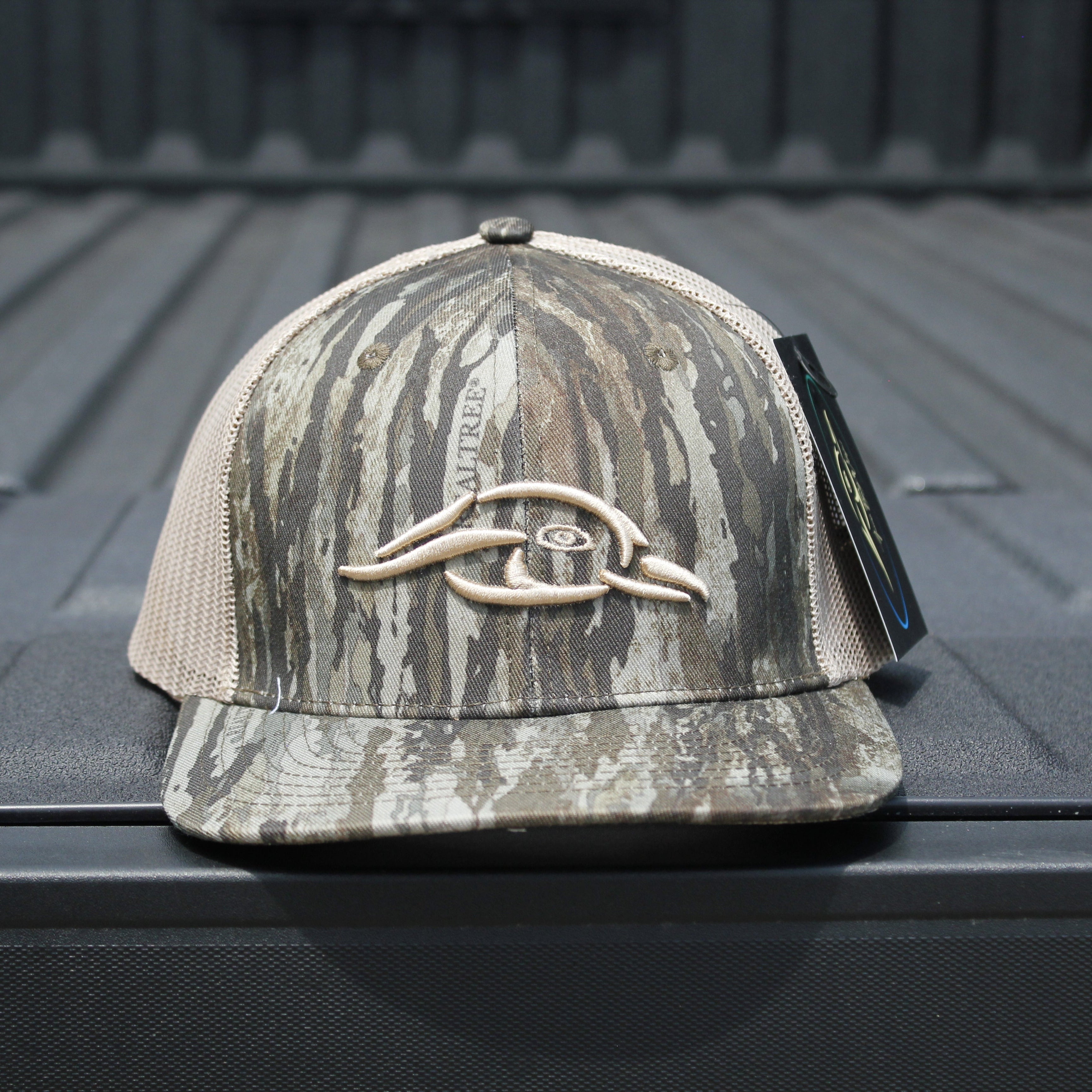 American Flyway Waterfowl trucker hat — mesh back detail with AFW duck logo on a truck bed