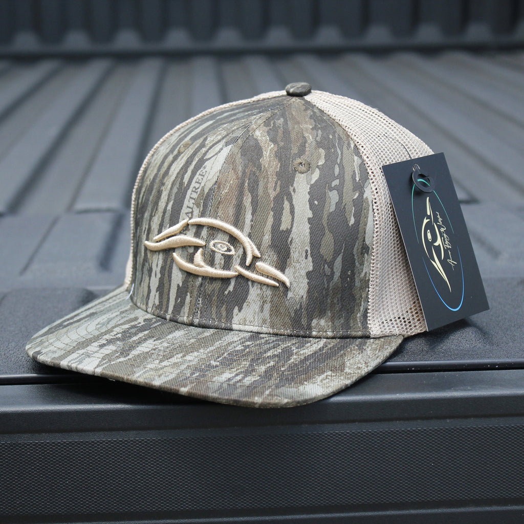 AFW Duck Logo Trucker Hat — side profile of Realtree Legacy camo cap with brand logo on a truck bed