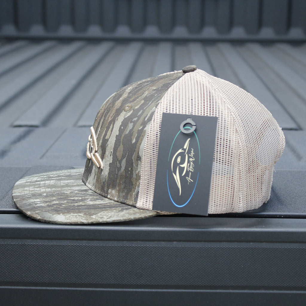 Camo and white baseball cap with a brand logo on a truck bed