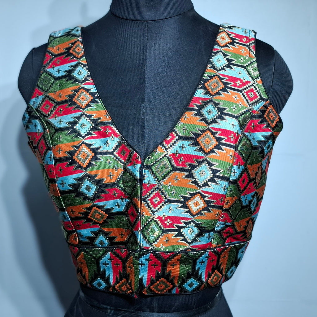 Black blouse featuring a multicolor geometric woven Patola pattern with V-neck.