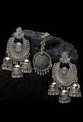 Silver jhumka earrings and matching maang tikka with intricate ethnic designs