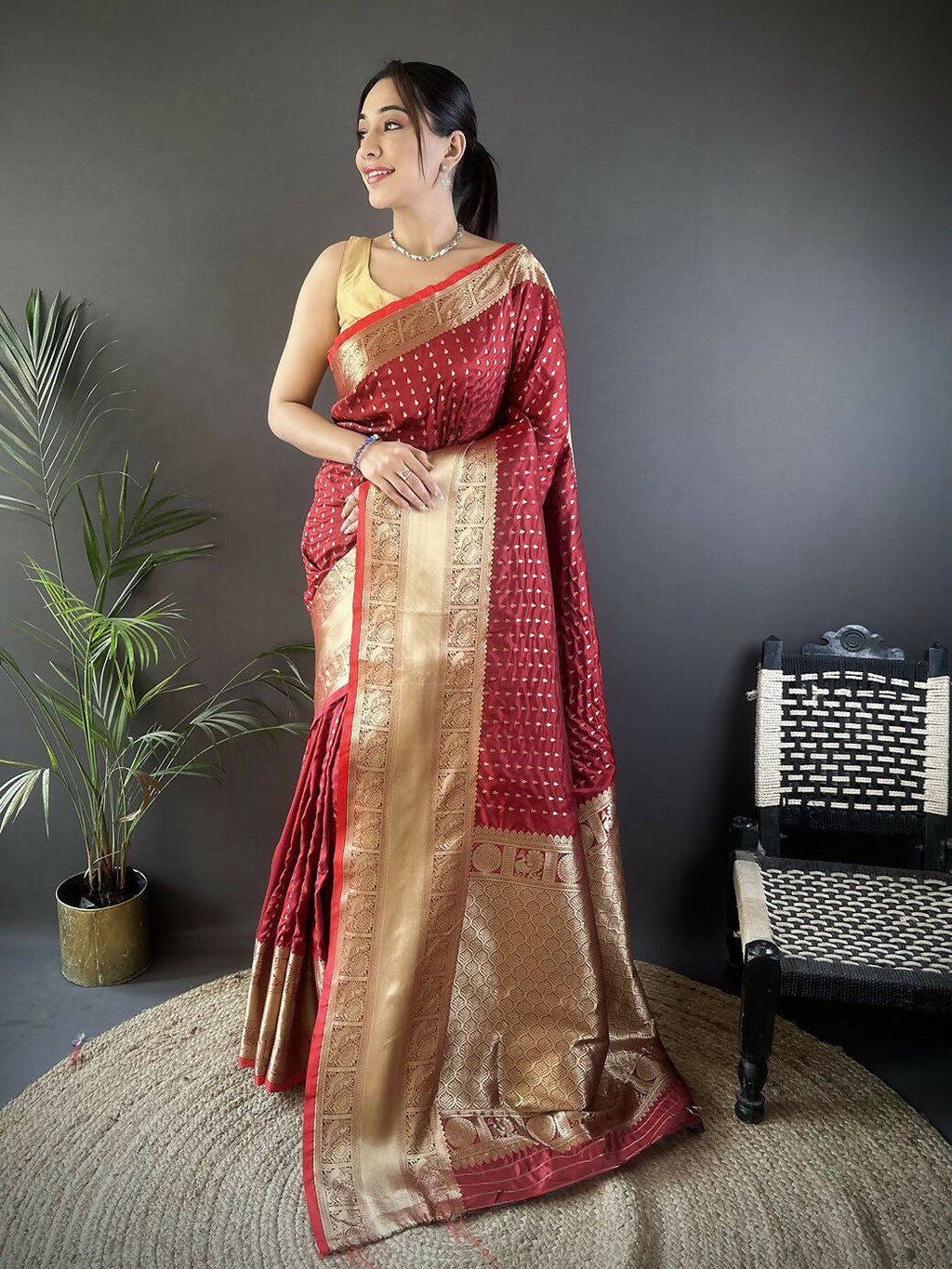 Brick red Banarasi silk saree with small butti motifs and unstitched blouse.