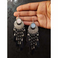 Oxidized silver half-moon style earrings decorated with soft silk thread hangings.