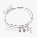 Silver-tone bangle featuring a mother-of-pearl umbrella charm and blue crystal raindrops