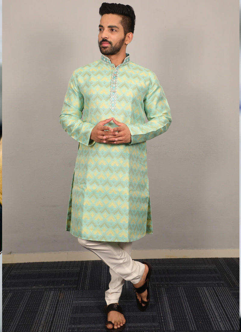 Men's light green silk kurta featuring heavy embroidery on the neckline