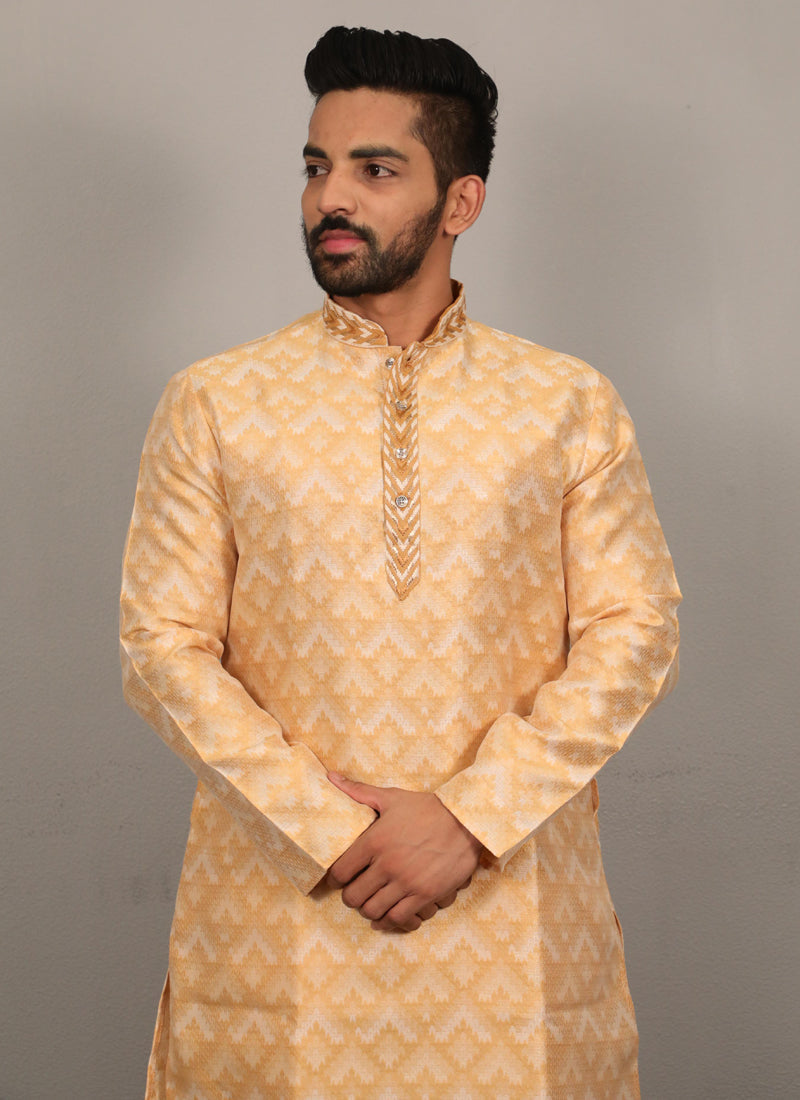 Men's light yellow silk kurta featuring an intricate jacquard pattern and heavy neck embroidery detail.