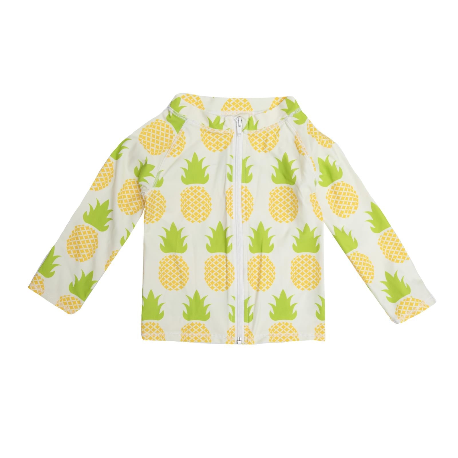 Woman wearing a zip-front long sleeve swim cover-up with a pineapple print on a beach.