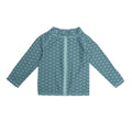 Child wearing a long sleeve zip-front swim cover up with a teal wave print in Summer Sky