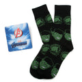 A pair of black crew socks with a repeating green Hulk face and fist pattern alongside a silver and red Avengers logo lapel pin.