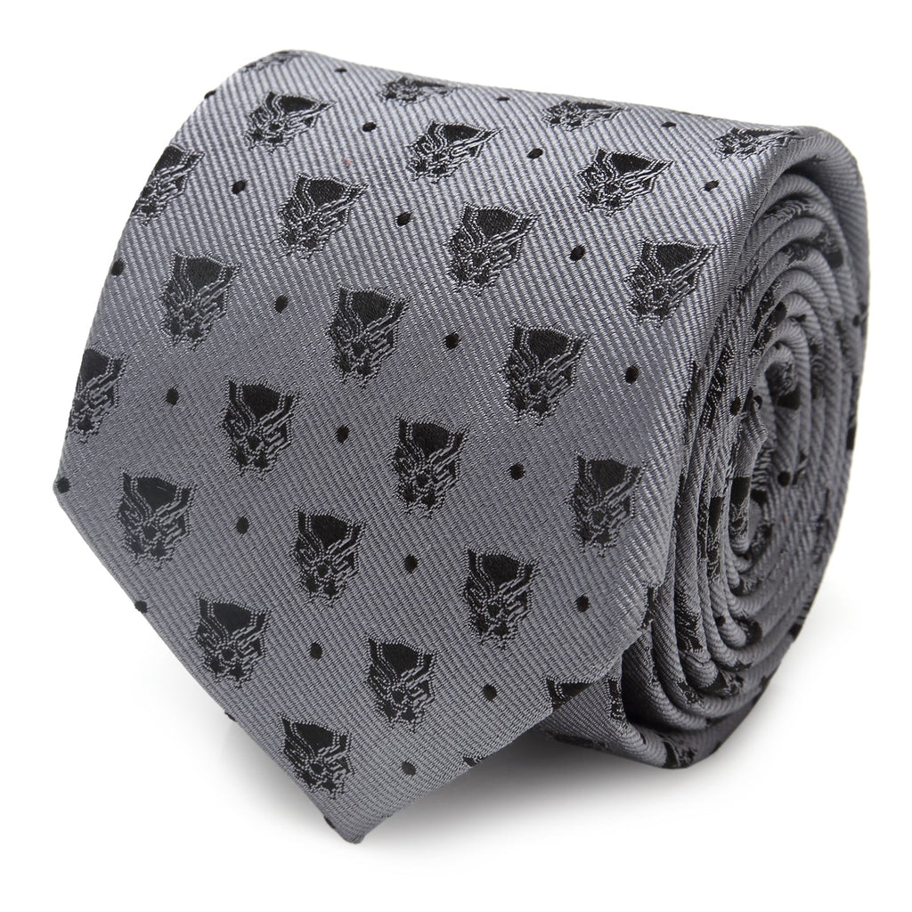 Close up of a gray silk tie with a repeating black Marvel Black Panther mask and small dot pattern