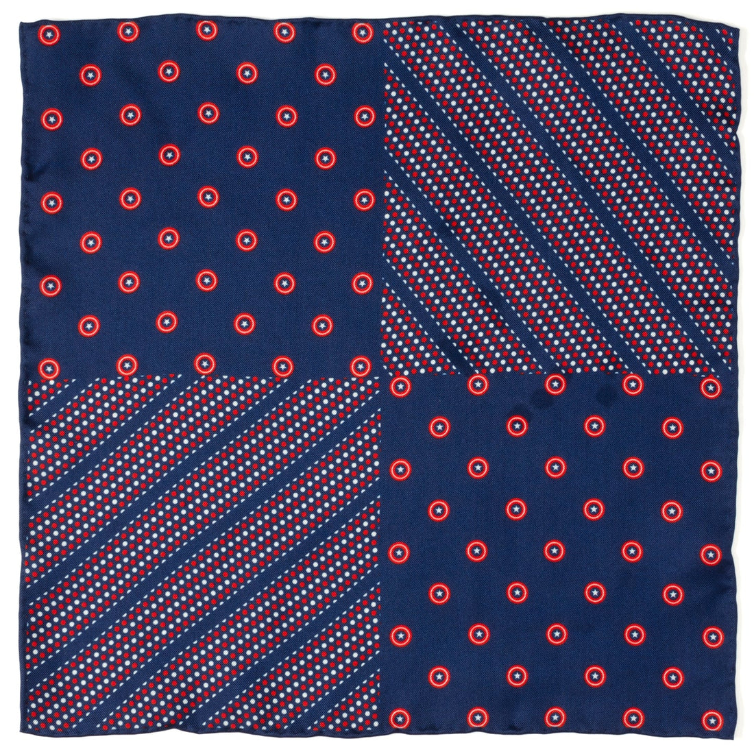 Close up view of a navy blue pocket square featuring red and white Captain America shield motifs tucked into a grey suit jacket pocket.