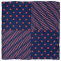 Close up view of a navy blue pocket square featuring red and white Captain America shield motifs tucked into a grey suit jacket pocket.