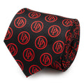 Close-up of a black men's necktie with a repeating red Daredevil DD logo pattern