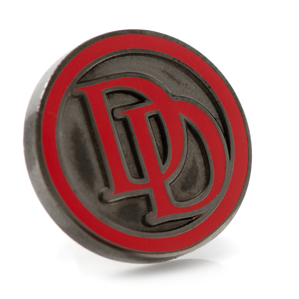 Close-up of a circular Marvel Daredevil lapel pin with a red logo on a gunmetal background