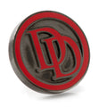 Close-up of a circular Marvel Daredevil lapel pin with a red logo on a gunmetal background