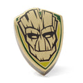 Close-up of a shield-shaped Marvel Groot lapel pin featuring a bronze bark texture against green and yellow accents.