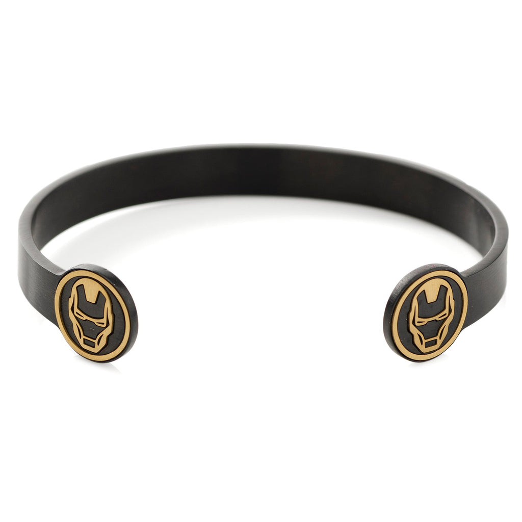 A sleek black plated metal cuff bracelet featuring gold-tone Iron Man helmet emblems on each end, worn on a wrist.