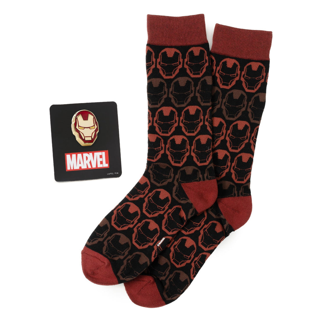 A gift set containing a pair of black and red patterned Marvel Iron Man crew socks and a gold and red Iron Man helmet enamel lapel pin.