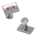 A pair of silver-tone cufflinks shaped like a retro cassette tape labeled Awesome Mix Vol. 2 with red and white details.