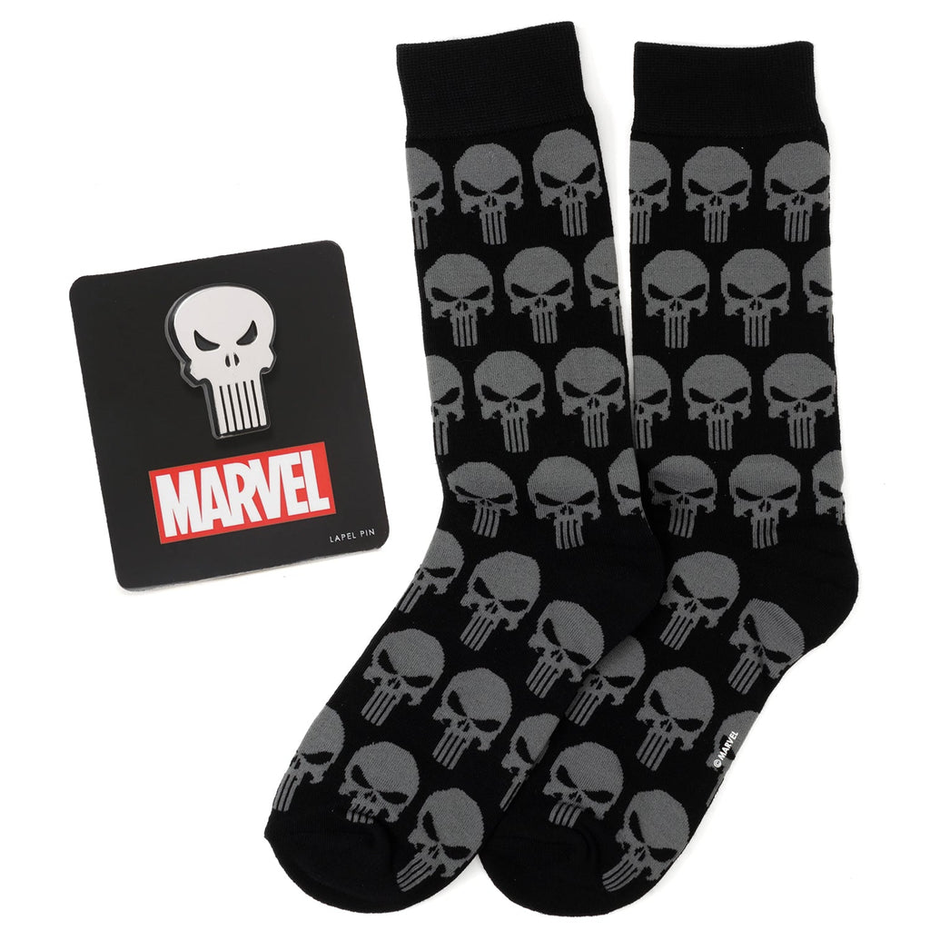 Marvel Punisher black crew socks with grey skull pattern and a silver Punisher skull lapel pin displayed on a white background.