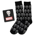 Marvel Punisher black crew socks with grey skull pattern and a silver Punisher skull lapel pin displayed on a white background.