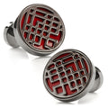 Close-up of circular Marvel Shang-Chi Ten Rings cufflinks in gunmetal with a bold red background.