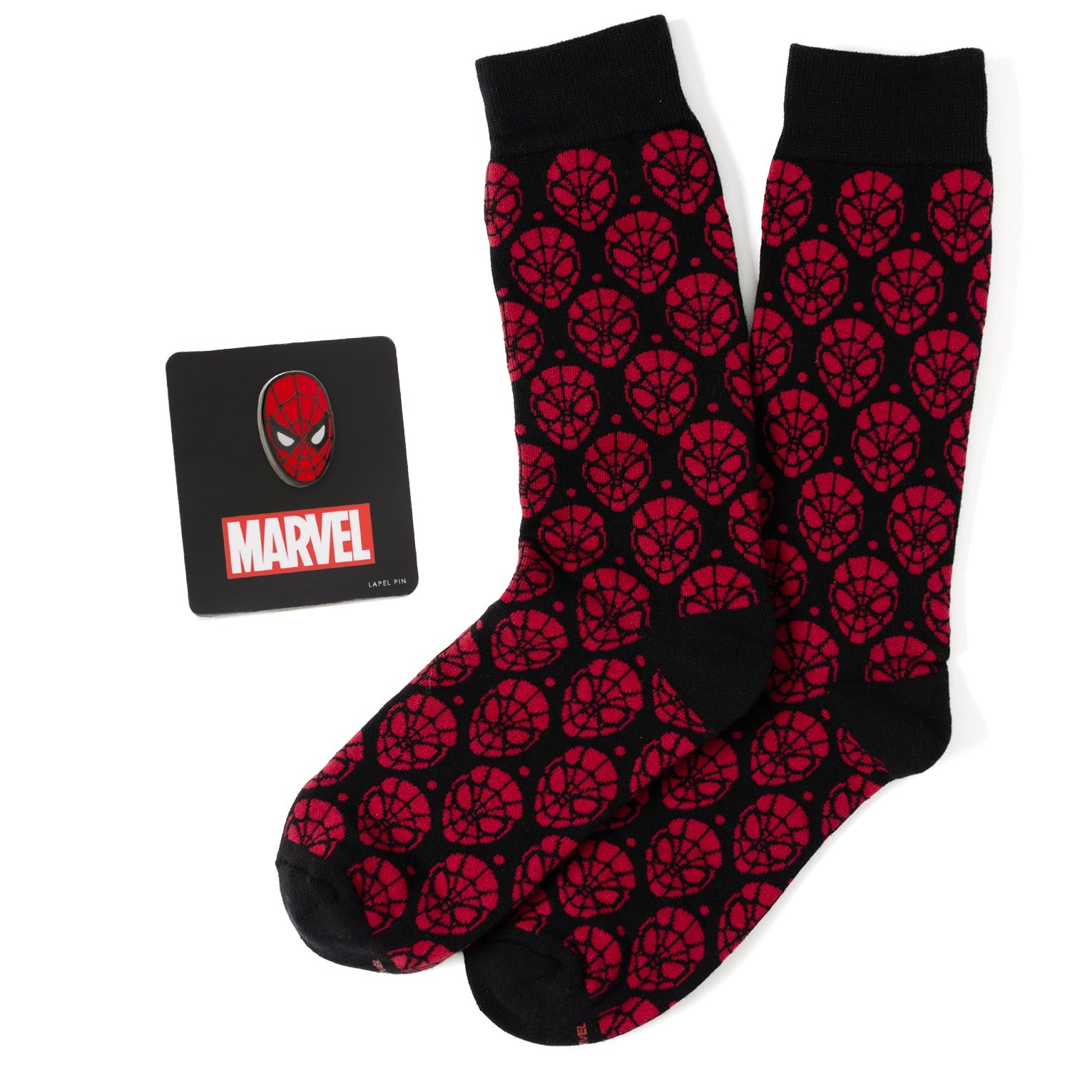 A pair of red and black Spider-Man patterned crew socks next to a Marvel Spider-Man mask lapel pin.