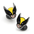Close up of Marvel Wolverine mask shaped cufflinks in black and yellow metal on a white background
