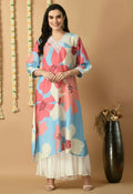 A woman wearing a vibrant floral print Maslin kurta set in bohemian fusion style.