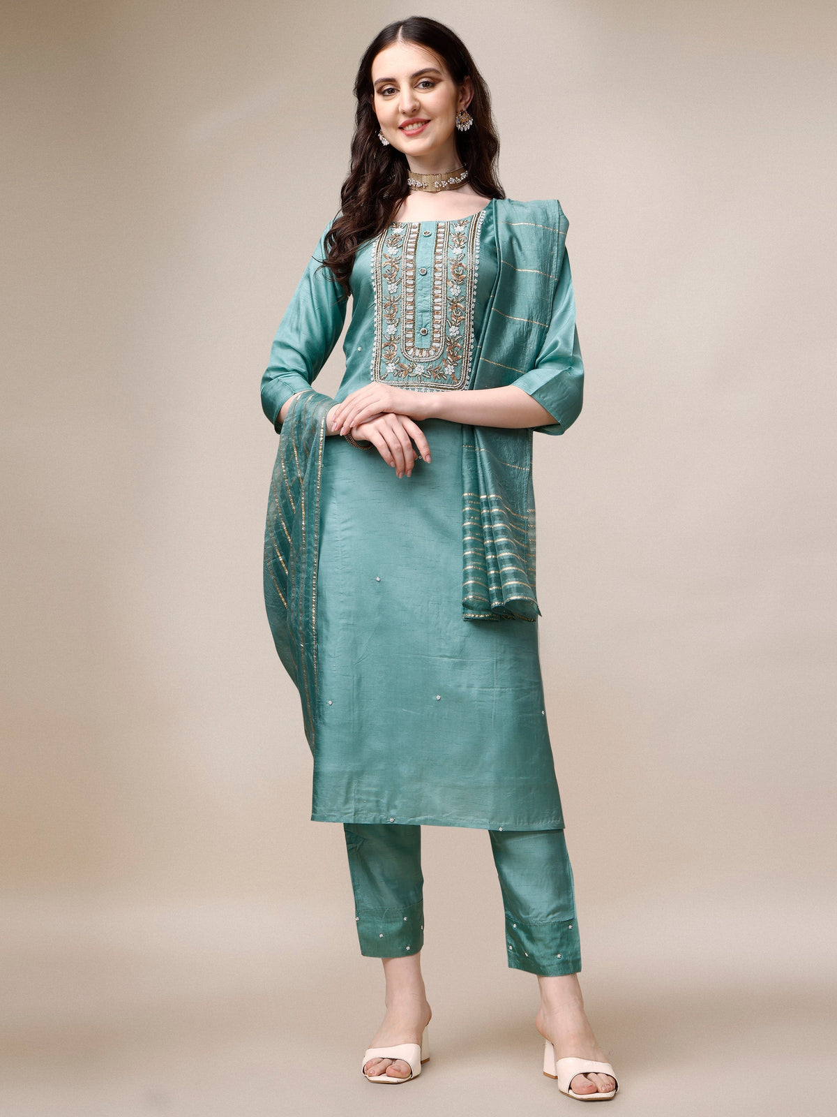 Woman wearing a multicolor embroidered rayon kurta set with matching pants and dupatta.