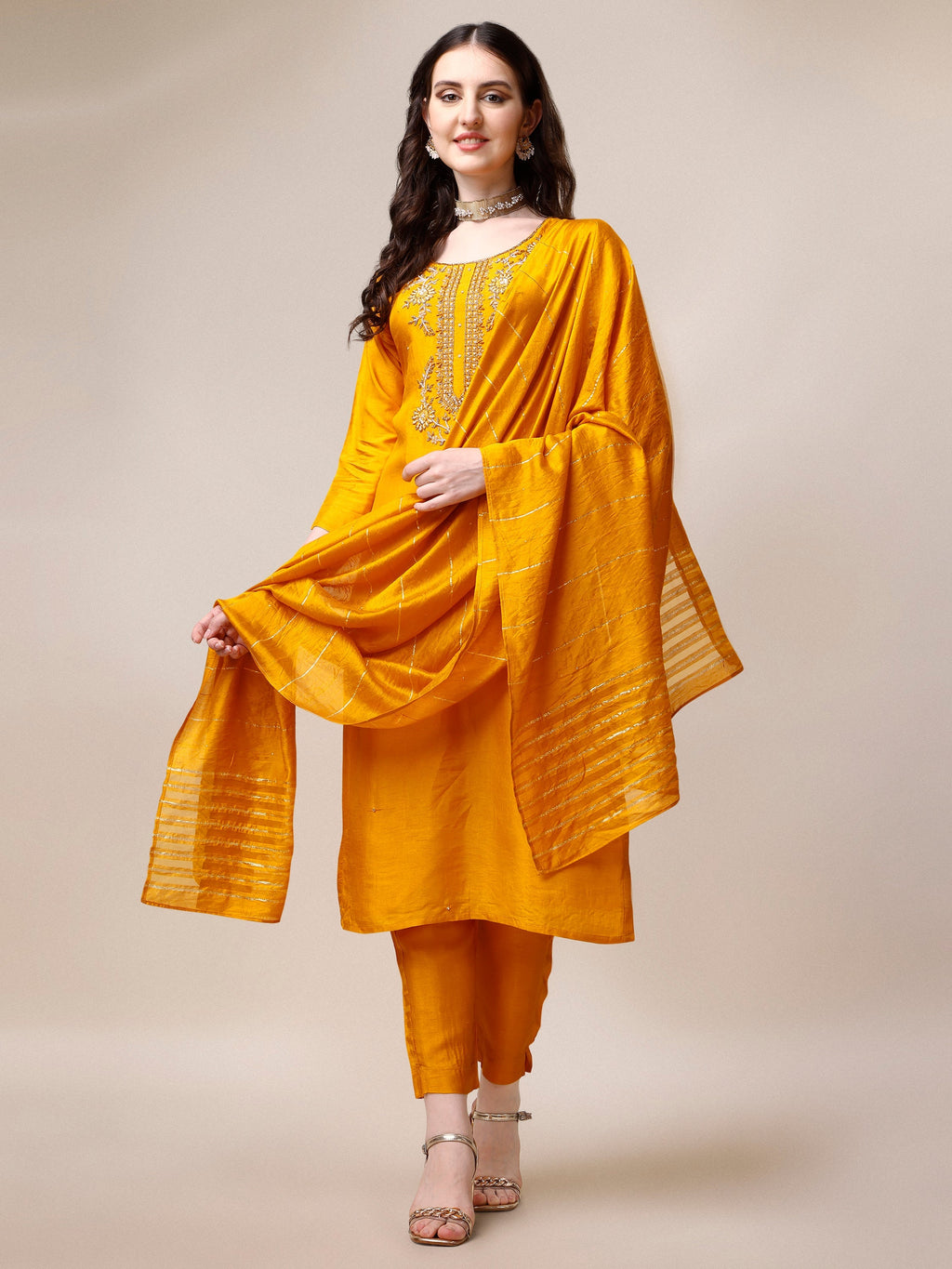 Woman wearing a multicolor embroidered rayon kurta set with matching pants and dupatta
